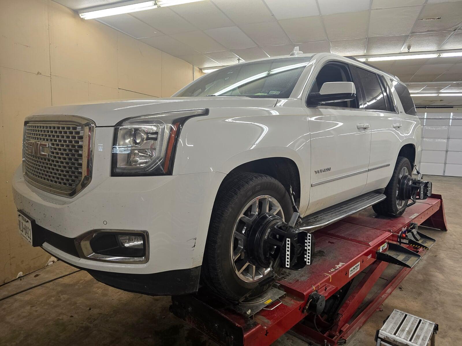 <Car on lift getting an alignment at Bolt Auto Care>