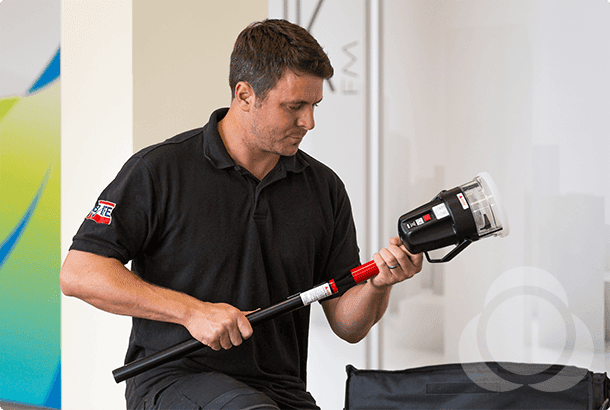 A man assembling a detector tester product for testing fire detectors.