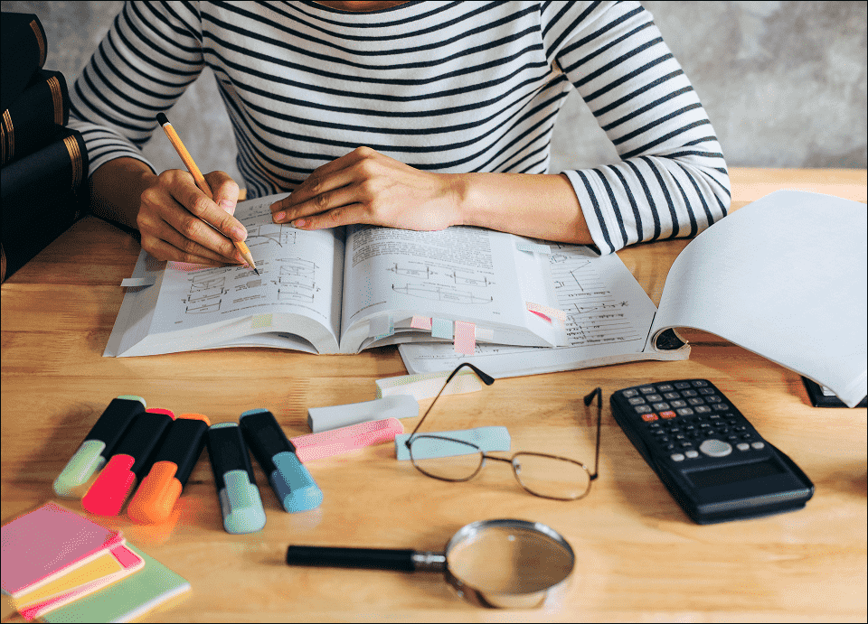 Woman at study desk South Africa using Pearson precalculus textbook and open source math textbooks. Woman at study desk South Africa using Pearson precalculus textbook and open source math textbooks.