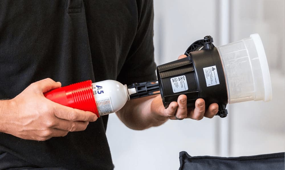 Demonstration of Solo detector tester in use, held by a professional for fire safety checks. Demonstration of Solo detector tester in use, held by a professional for fire safety checks.