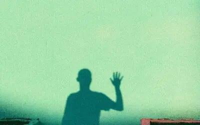 Man waving in shadow  Man waving in shadow