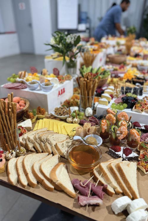 Close-up on bread selection and luxury canapes and finishing touches on ABB grazing table