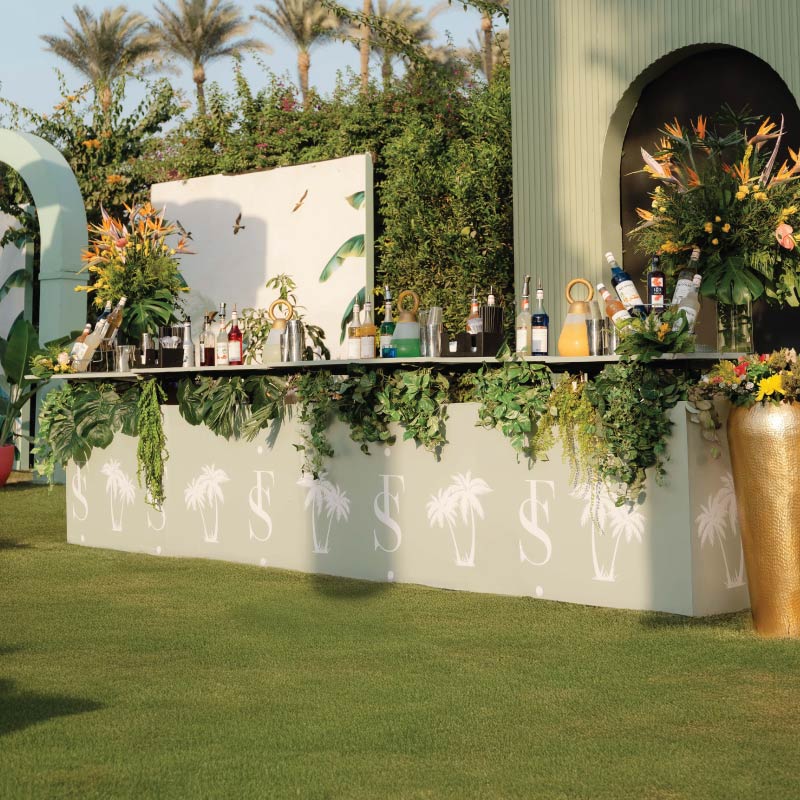 Tropical-themed LOriental Live Bar styled with greenery and floral décor