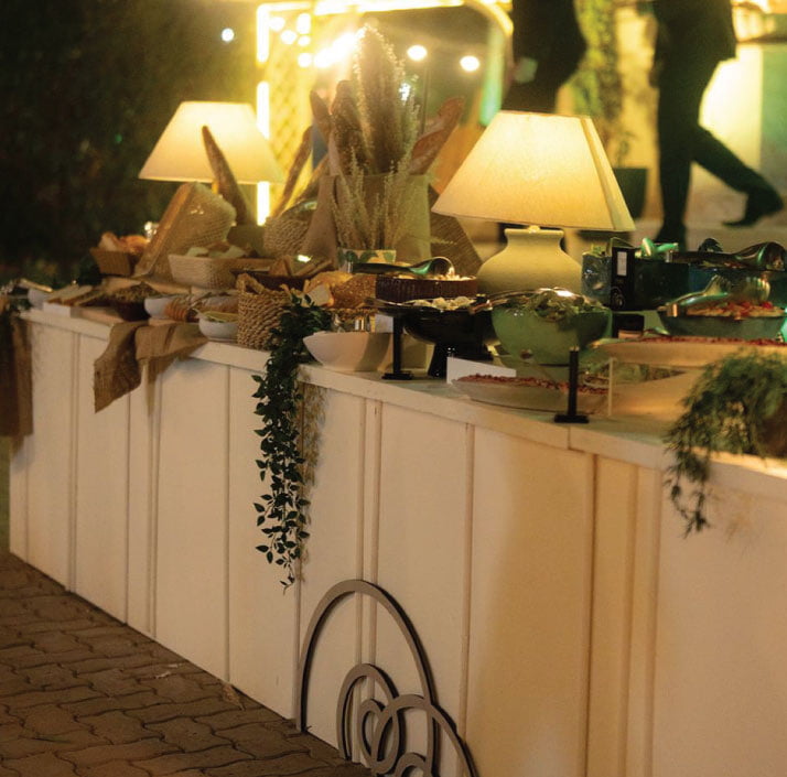 Styled bread and buffet station with ambient table lamps and event décor Styled bread and buffet station with ambient table lamps and event décor