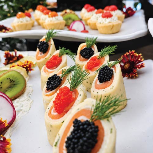 Smoked salmon and caviar crepe roulade breakfast item at British Embassy event