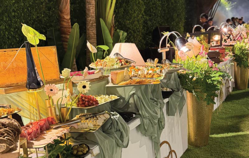 Styled outdoor open buffet with floral arrangements and premium catering setup by LOriental