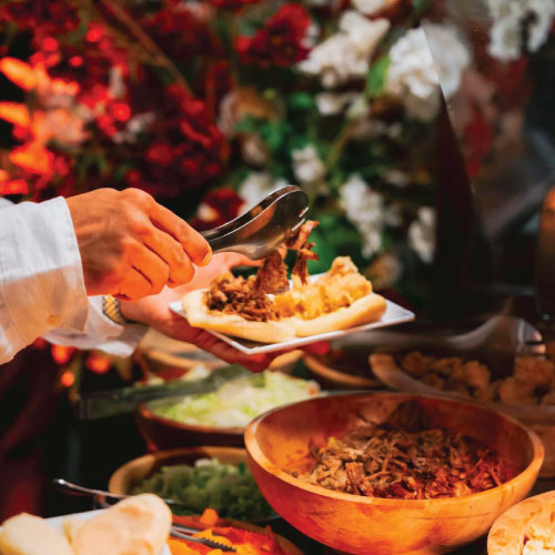 Guest choosing bao bun fillings at LOriental event in Bir Youssef