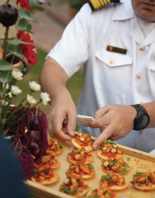 Military officer in uniform selecting a canapé from LOriental’s theatrical pass-around tray at Canada Day 2026 in Cairo Military officer in uniform selecting a canapé from LOriental’s theatrical pass-around tray at Canada Day 2026 in Cairo