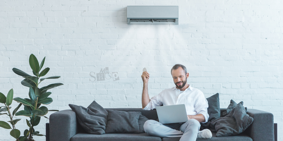 A modern white 2 Ton Split AC unit from Me Shop installed on a stylish living room wall.