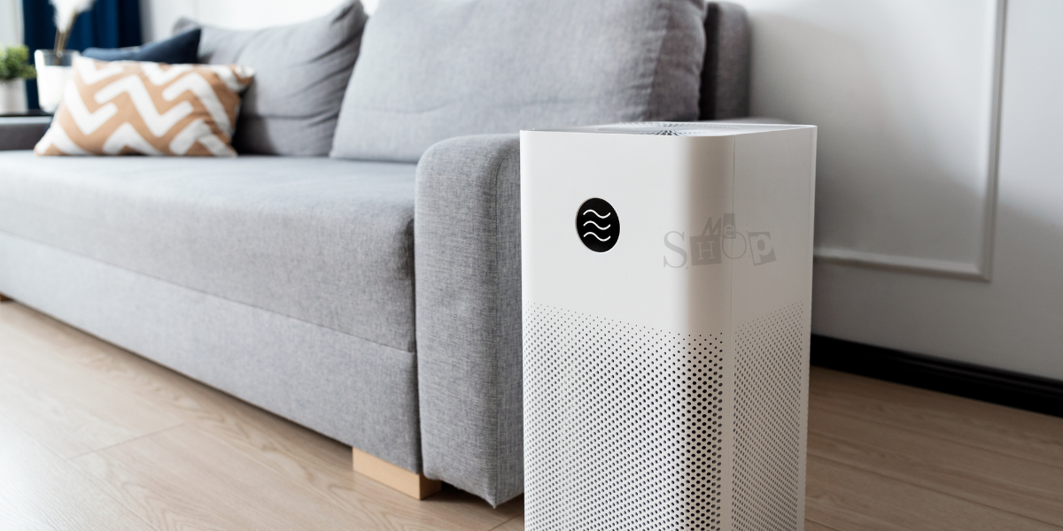 A modern white air purifier in a clean living room.
