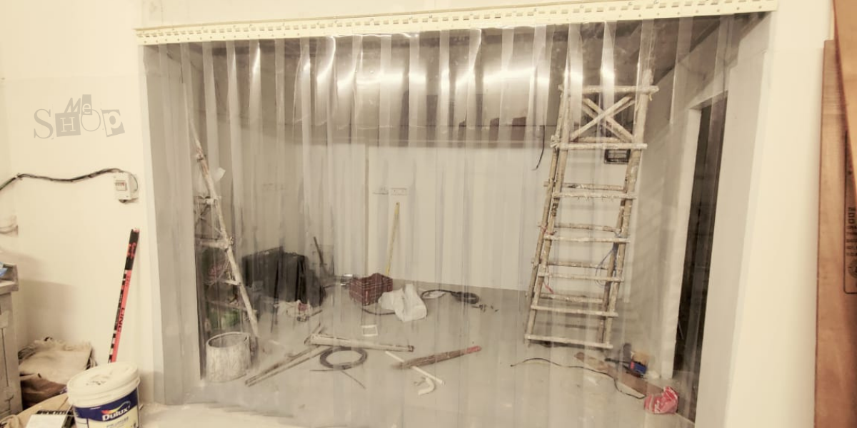 Blue transparent PVC strip curtain in a Gurgaon warehouse doorway.