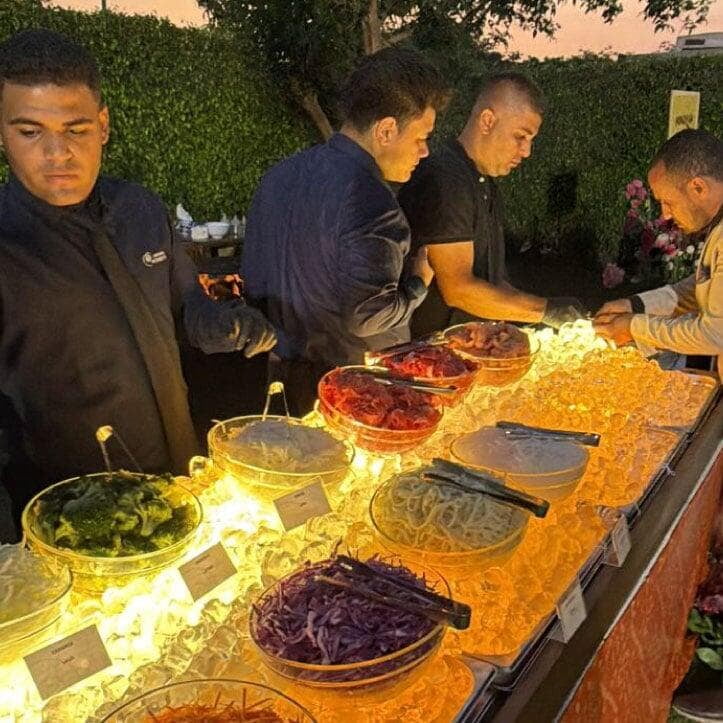 Finishing touches on Mongolian Grill cold ingredient display