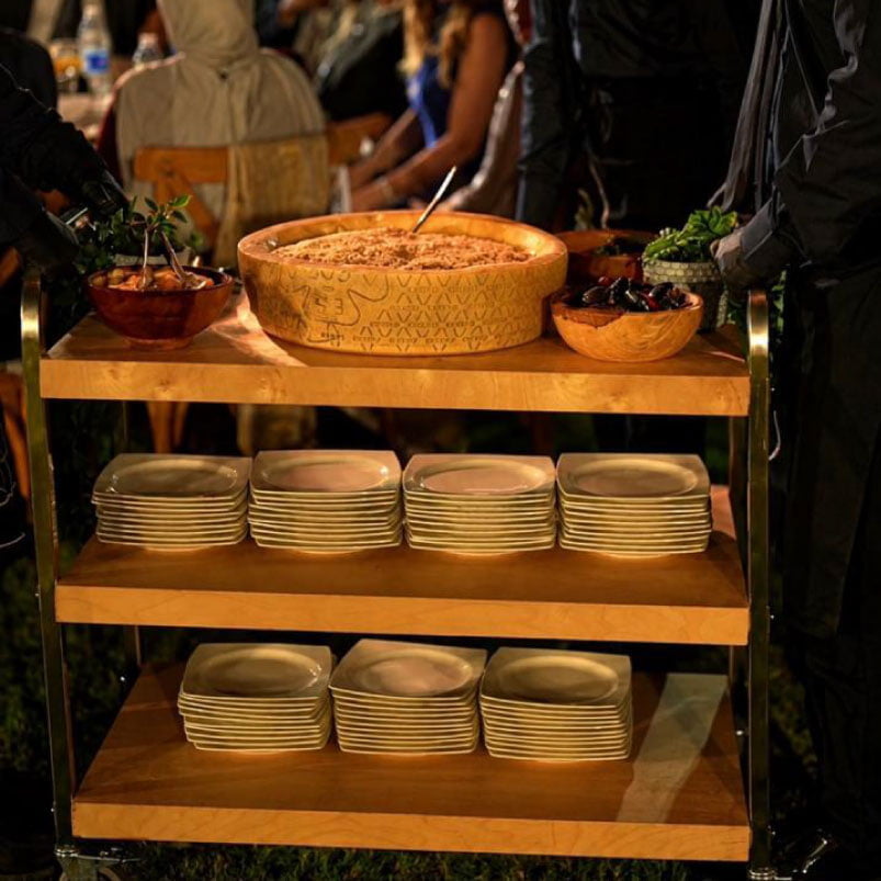 Live table-side Risotto Rêverie experience station served to guests from decorated food trolley Live table-side Risotto Rêverie experience station served to guests from decorated food trolley