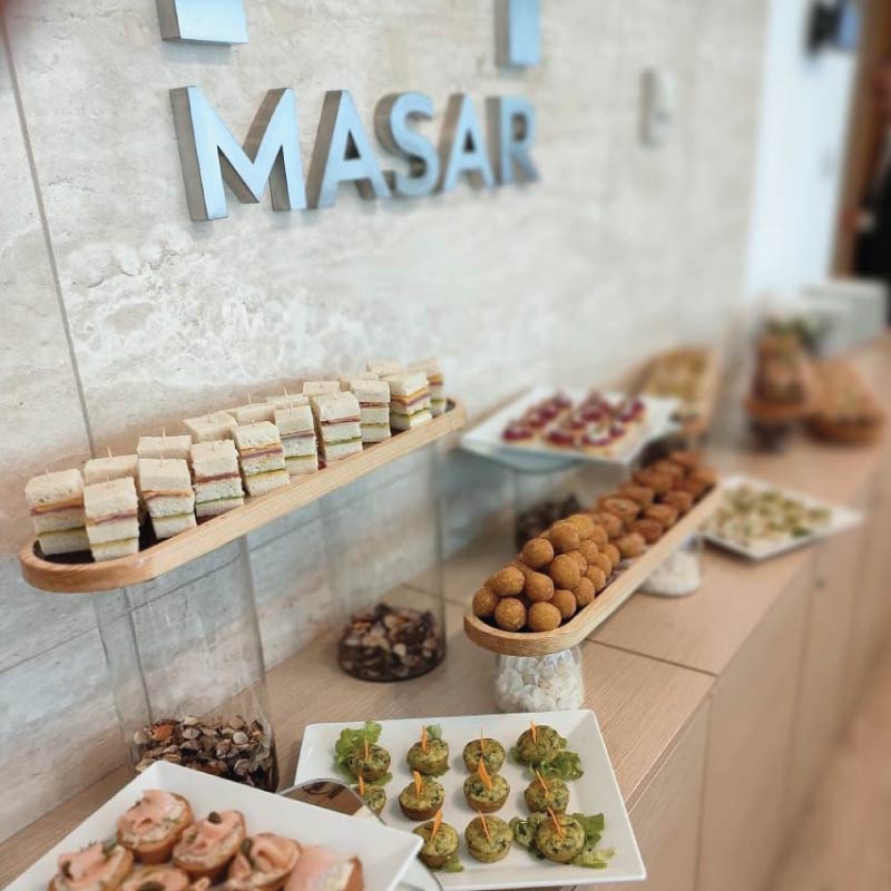 Finger food buffet at MASAR Financial Advisory with logo stainless steel letters on wall