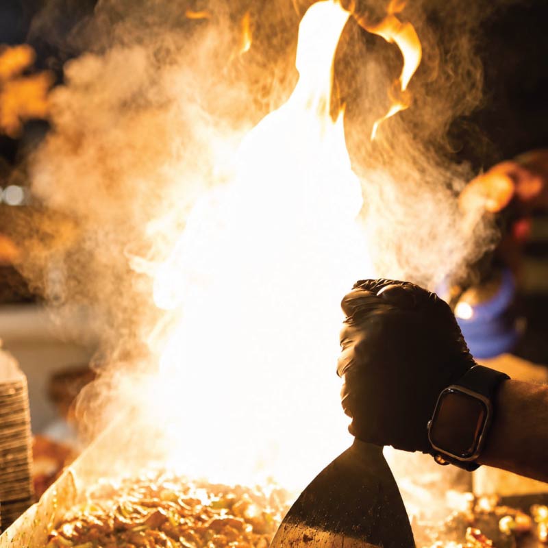 LOriental live culinary station with dramatic flame cooking and guest-facing food preparation during an event in Cairo LOriental live culinary station with dramatic flame cooking and guest-facing food preparation during an event in Cairo