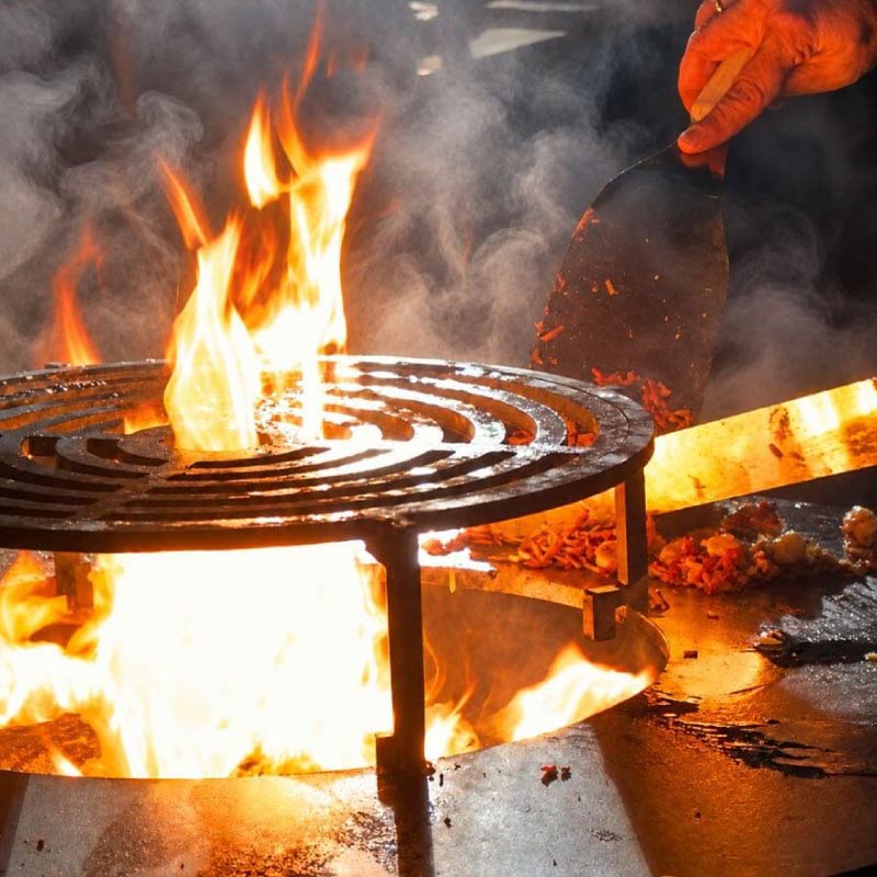 Fire showing from open flame grill on Mongolia Fire BBQ Grill live station at a LOriental catered event Fire showing from open flame grill on Mongolia Fire BBQ Grill live station at a LOriental catered event