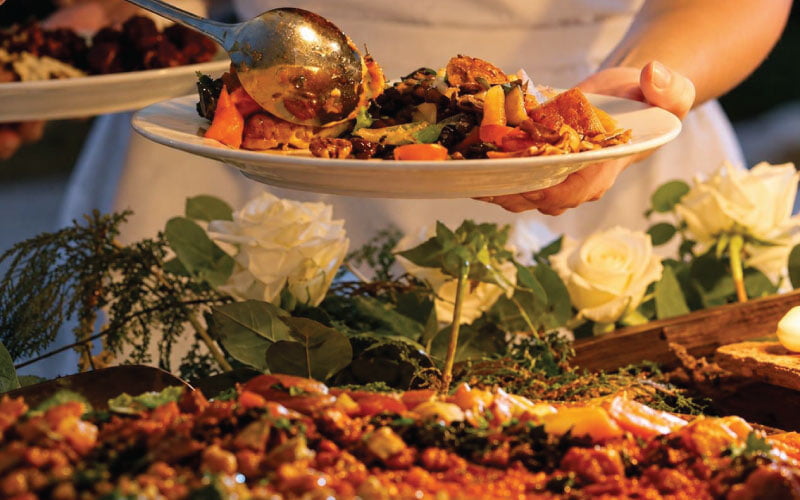 Woman serving food in dinner plate