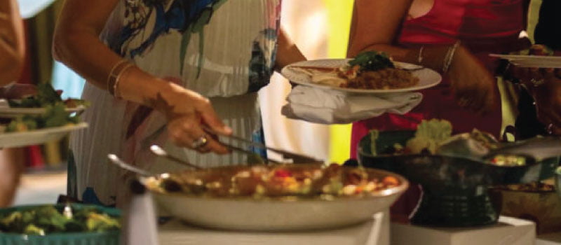 Guests serving salads from open buffet Guests serving salads from open buffet