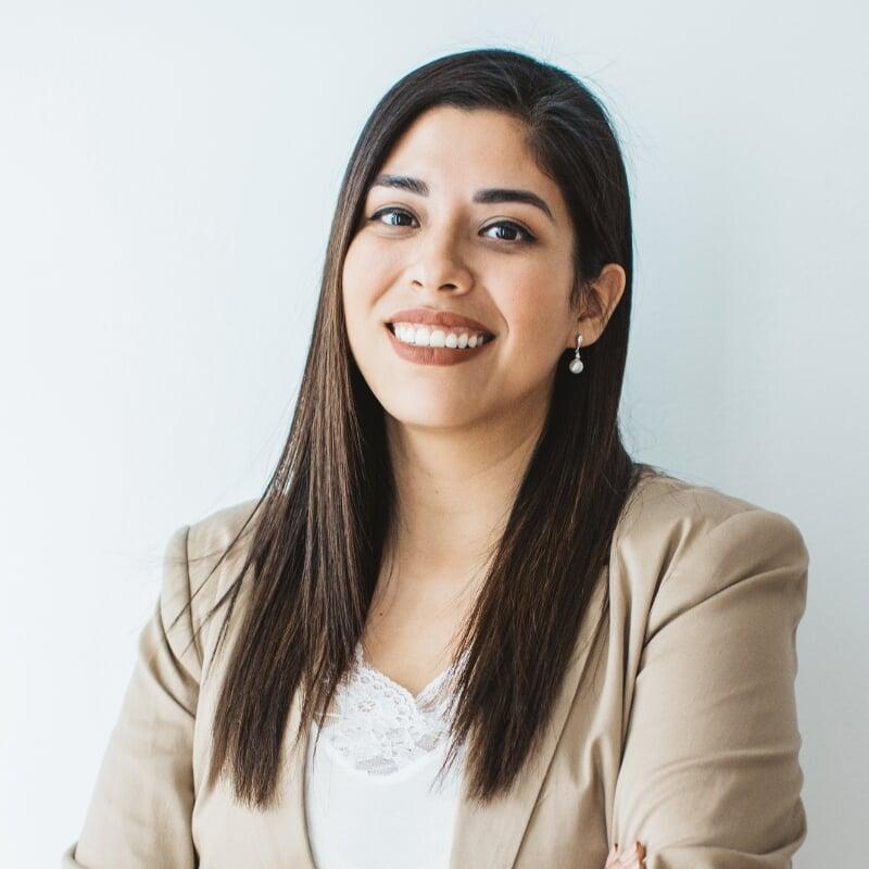 a smiling woman with long dark hair wearing a beige blazer and white blouse, captioned ‘BuzzFeed’ a smiling woman with long dark hair wearing a beige blazer and white blouse, captioned ‘BuzzFeed’