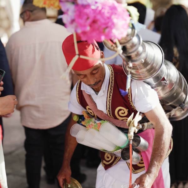 Traditional mobile beverage service moving among guests at an Indian wedding