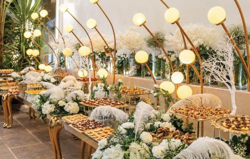 LOriental maximalist theatrical buffet with illuminated sculptural hardware, white florals and feathers at Sherif and Jana Katb Ketab in 6th of October, Egypt LOriental maximalist theatrical buffet with illuminated sculptural hardware, white florals and feathers at Sherif and Jana Katb Ketab in 6th of October, Egypt