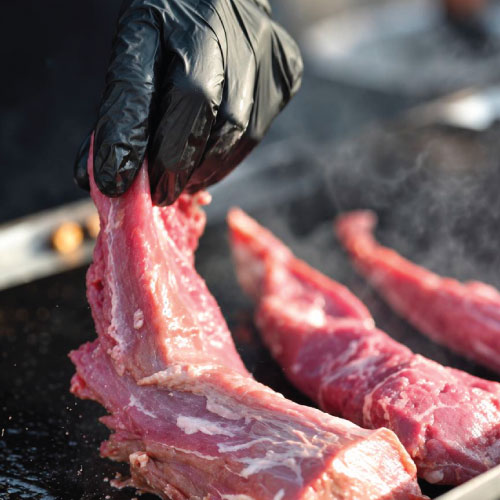 LOriental culinary team preparing fresh meat behind the scenes for event service LOriental culinary team preparing fresh meat behind the scenes for event service