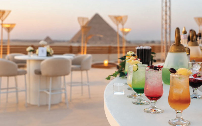 Various non-alcoholic cocktails on display on LOriental bar with Pyramids in the background