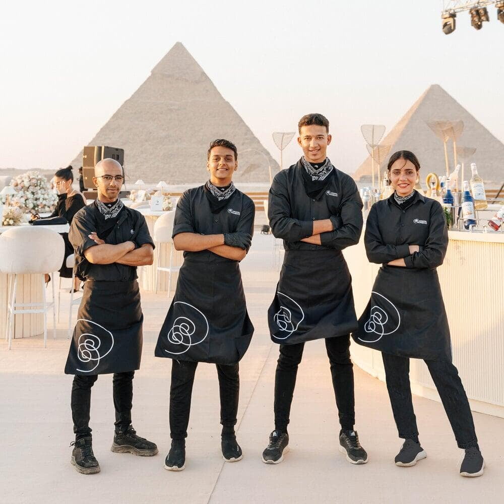 LOriental baristas posing at a pyramids event catered by LOriental on 16 Aug 2024