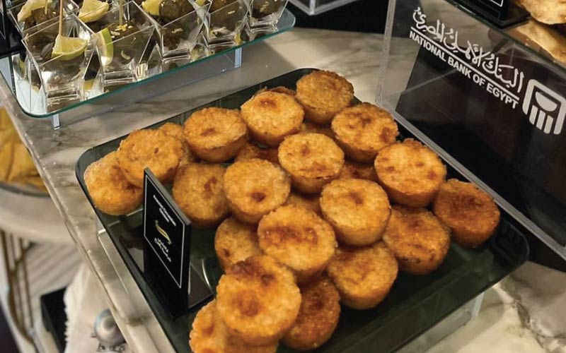 NBE Platinum lounge snacks on buffet with visible NBE branding on food risers NBE Platinum lounge snacks on buffet with visible NBE branding on food risers