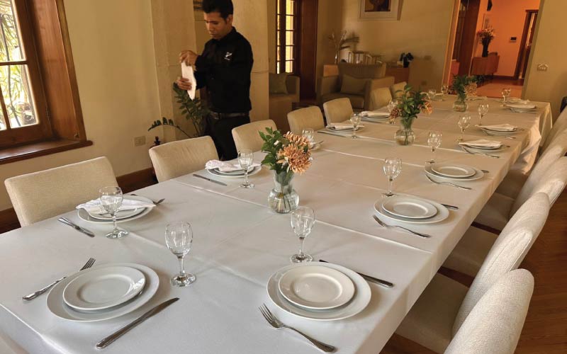 LOriental service member preparing dining table for New Zealand lunch event