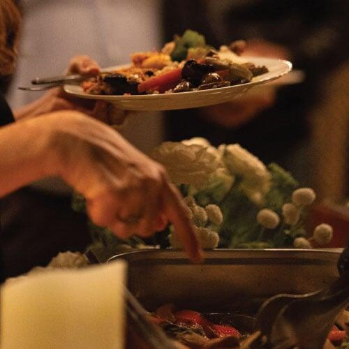 Guest pointing at main course open buffet item