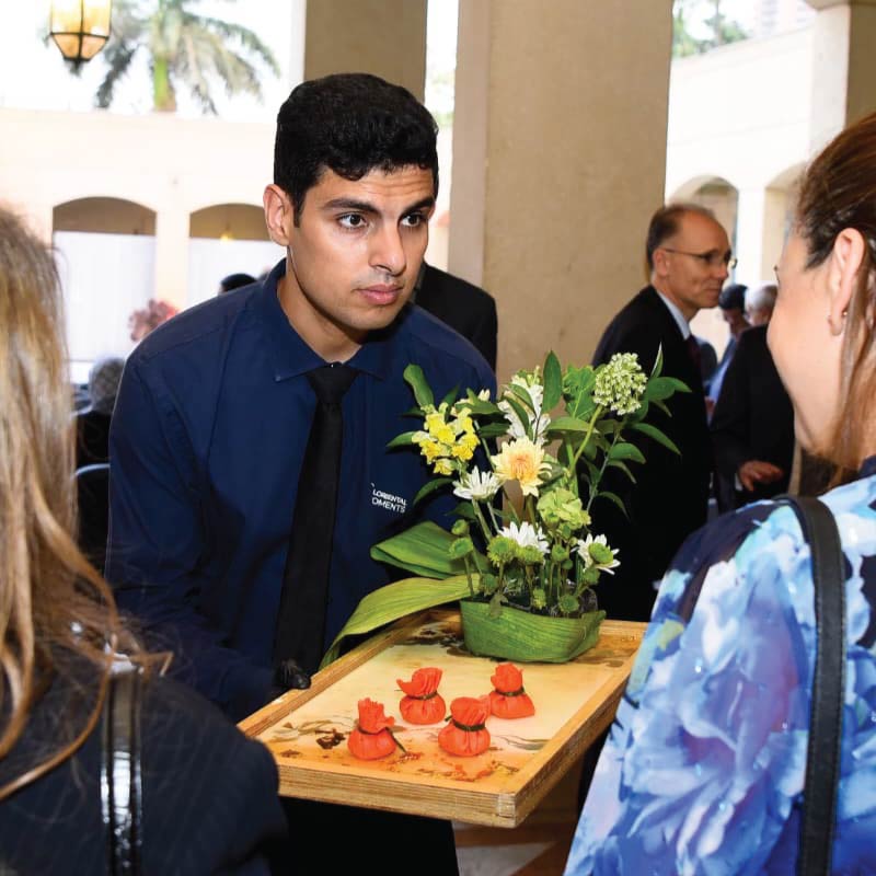 LOriental waiter serving experiential passarounds at Cairo Opera House