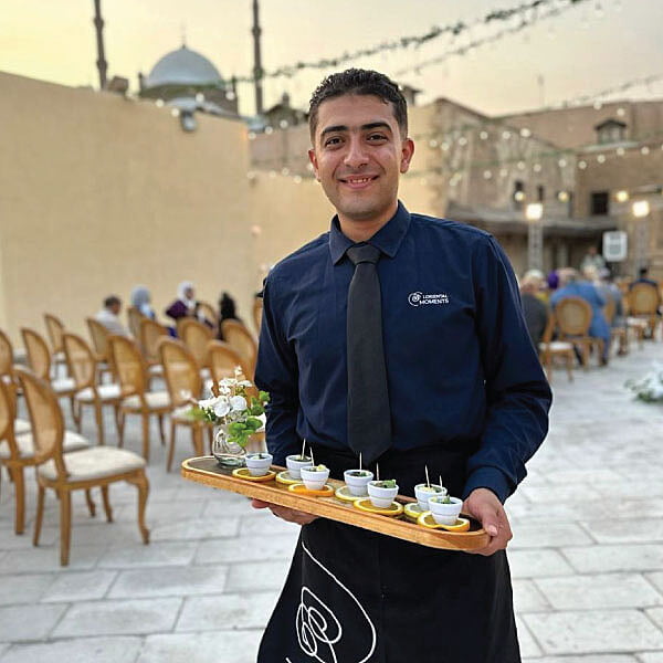 LOriental waiter with a canape tray posing at Dar Darb event on 23 October 2023 LOriental waiter with a canape tray posing at Dar Darb event on 23 October 2023