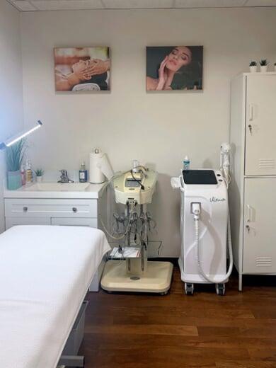 Facial and laser treatment room with a treatment bed and skin care machines at Vancouver Green Spa