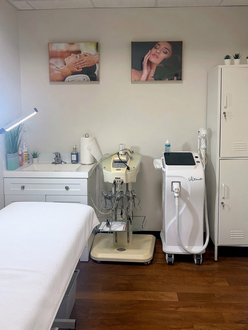 Facial and laser treatment room with a treatment bed and skin care machines at Vancouver Green Spa