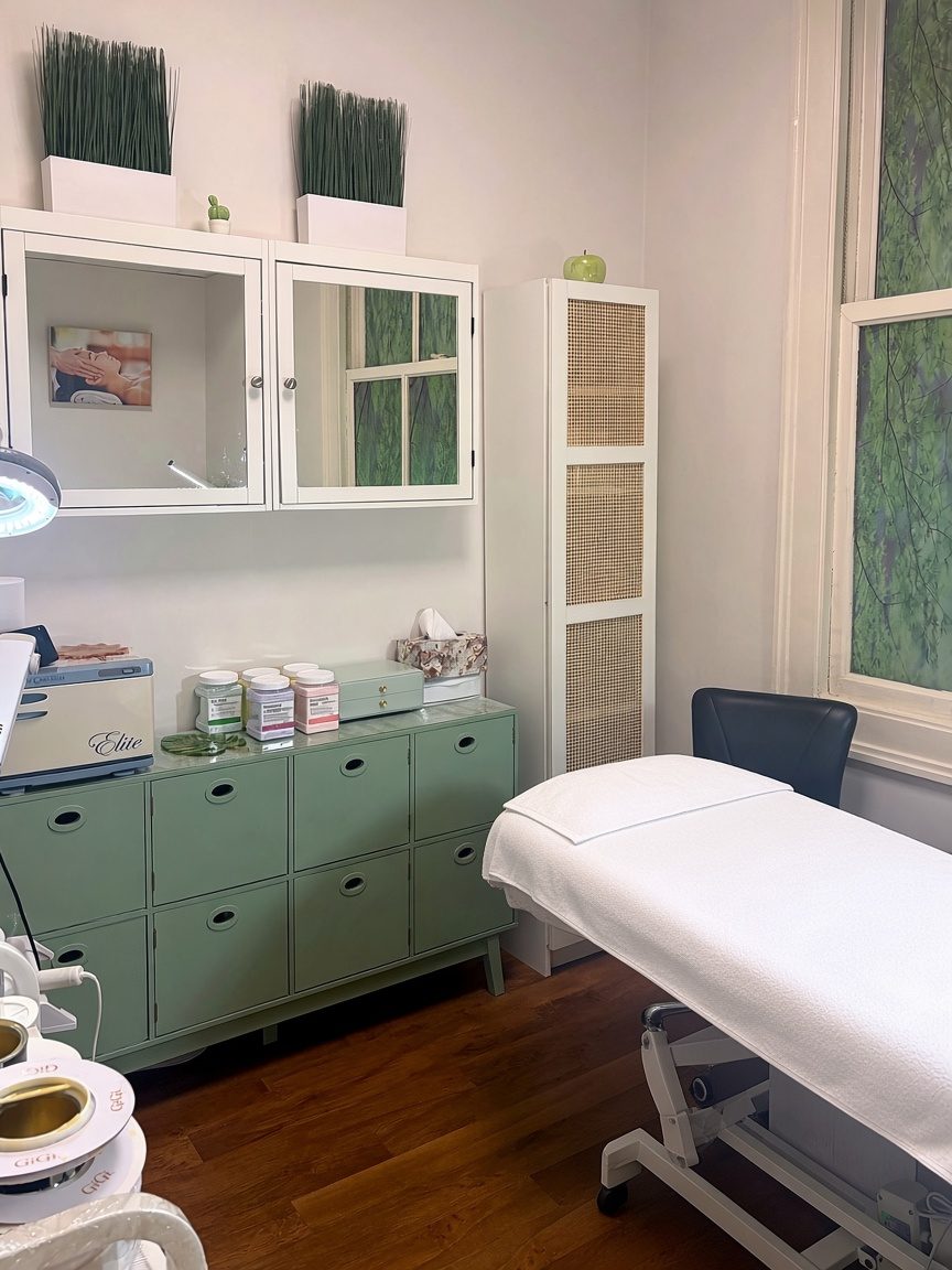 Bright, calm facial room with a neatly made treatment bed at Vancouver Green Spa