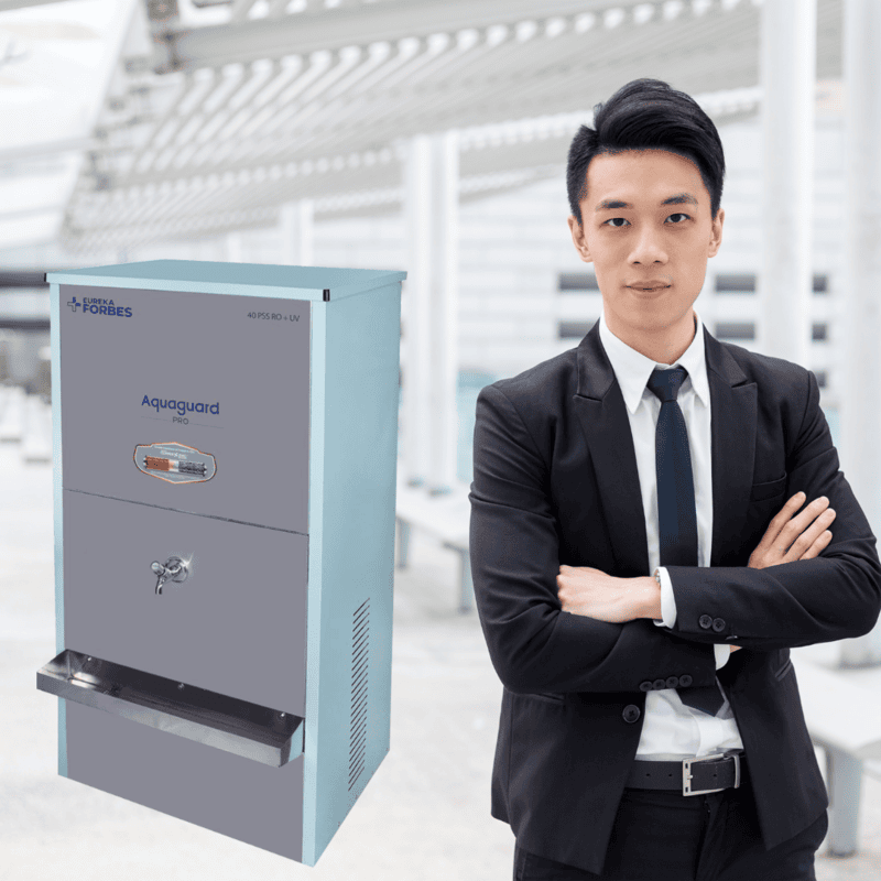 A person dispensing mineral-enriched water from the Aquaguard RO+UV+CuZn Water Purifier.