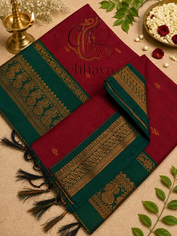Kalyani cotton blend with a maroon body and contrasting dark green border and pallu.