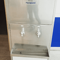 An employee dispensing pure, chilled water from the Blue Star SWCSDLX6080UVROE in a factory setting. An employee dispensing pure, chilled water from the Blue Star SWCSDLX6080UVROE in a factory setting.