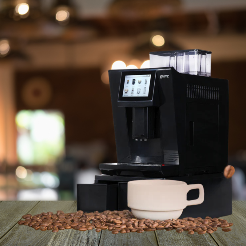 An employee enjoying a coffee break in an office with the Atlantis Brew in the background.