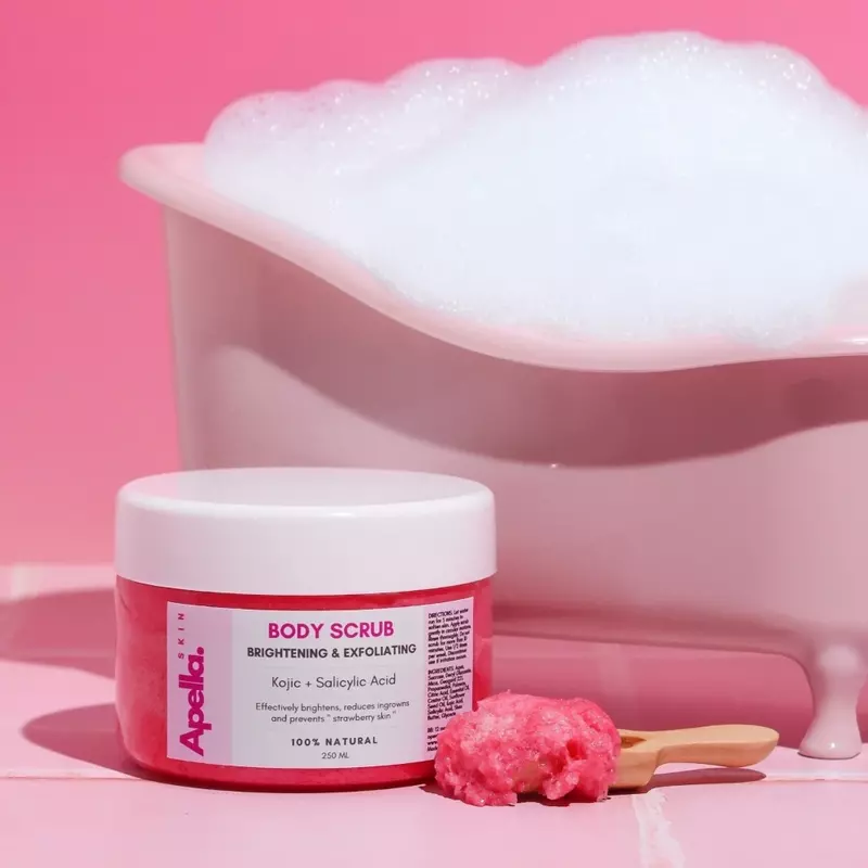 A jar of a Brightening Body Scrub with igredients like Kojic and Salicylic Acid