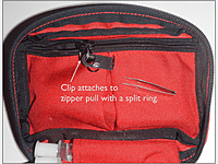 The clip attaches to a zipper pull with a split ring