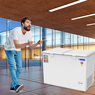 Customer Examining the Blue Star CF5-460NEYW Hard Top Freezer in a Store