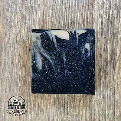 Unboxed Clean Slate goat milk soap with charcoal black, blue-gray, and cream swirls