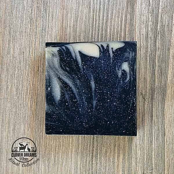 Unboxed Clean Slate goat milk soap with charcoal black, blue-gray, and cream swirls