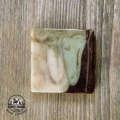 Unboxed Deep Roots goat milk soap with green, cream, and earthy brown swirls