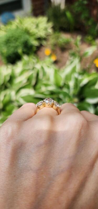 3 stone old mine cut lab diamond six prong ring on hand