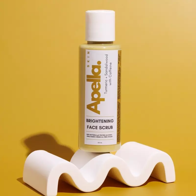 A bottle of Apella Skin Brightening Face Scrub with Turmeric and Caffeine.