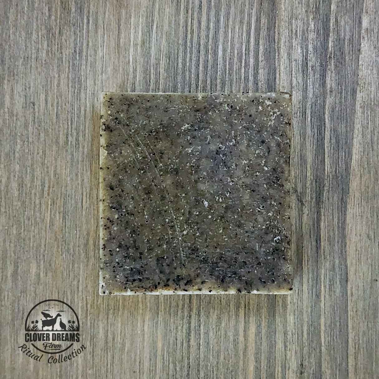 Unboxed Radiance goat milk scrub soap with a textured gray-green finish