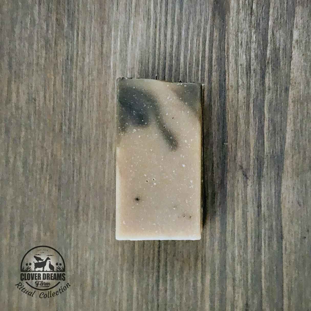 Unwrapped Rosemary Sage goat milk soap stick with soft green and cream coloring